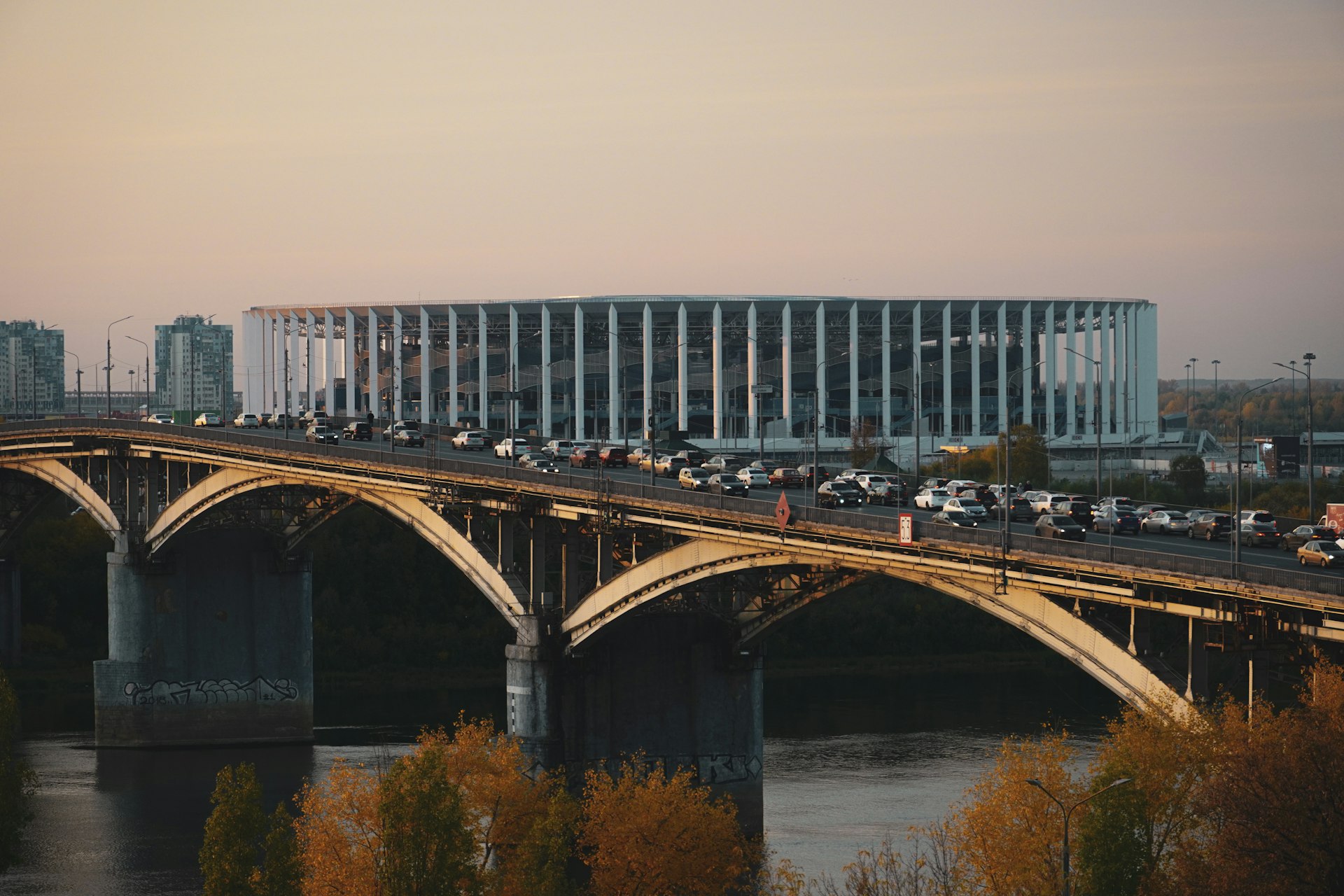 a bridge over a body of water with a building in the background