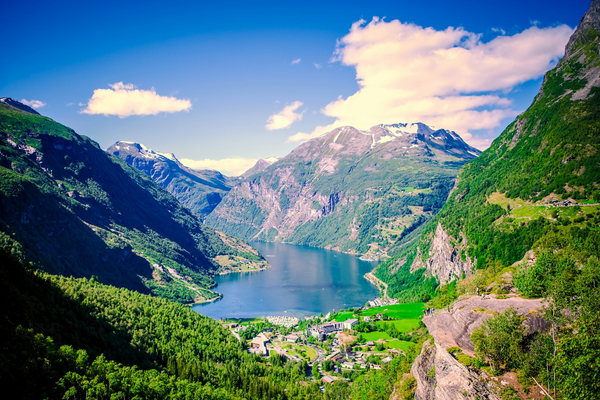 A scenic view of a valley with a lake in the middle