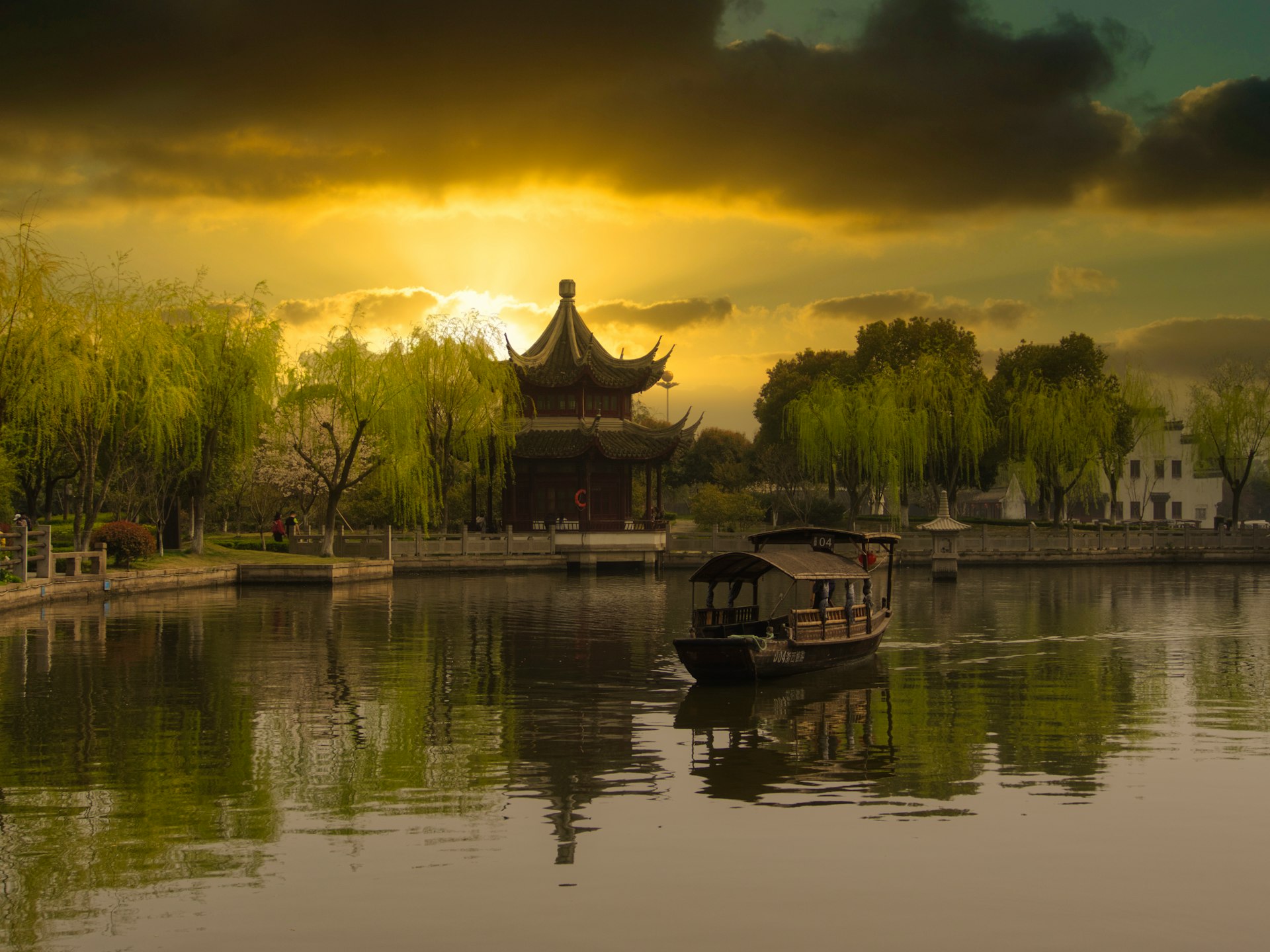 brown wooden house on lake during sunset