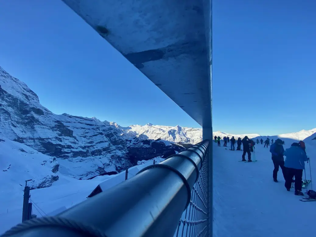 people walking on snow covered ground during daytime