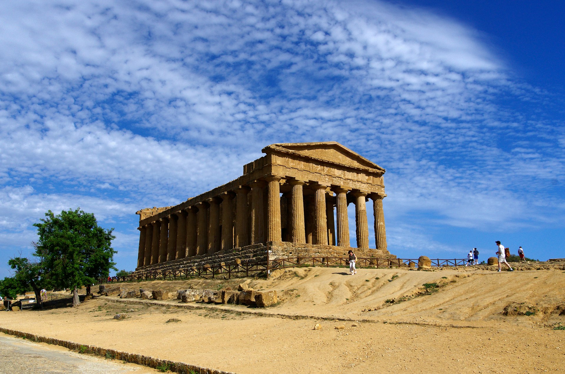 A large building sitting on top of a sandy hill