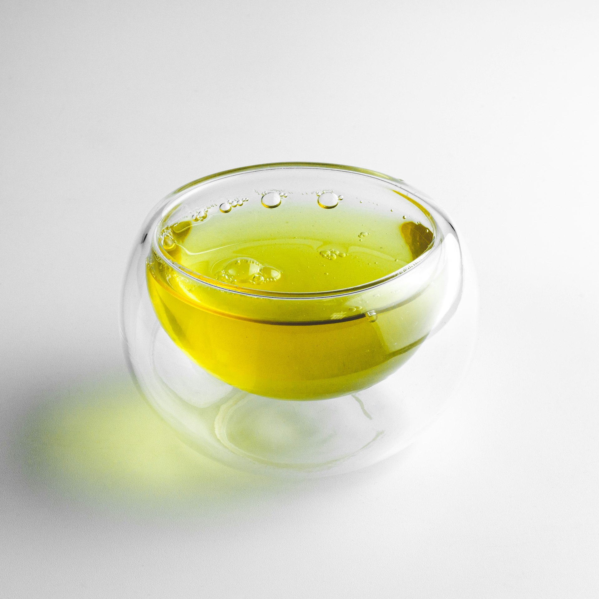 clear glass cup with yellow liquid