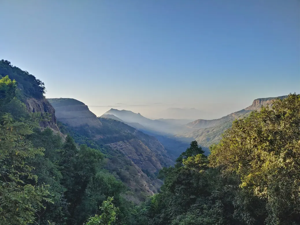 a view of a valley with mountains in the background