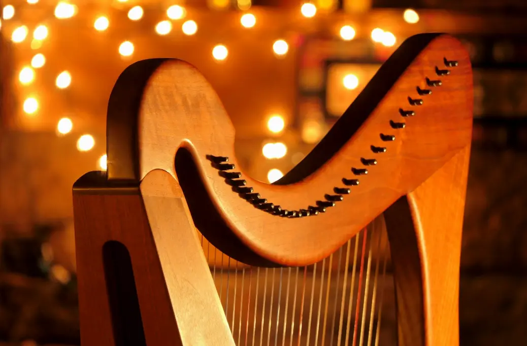 A close up of a musical instrument with lights in the background