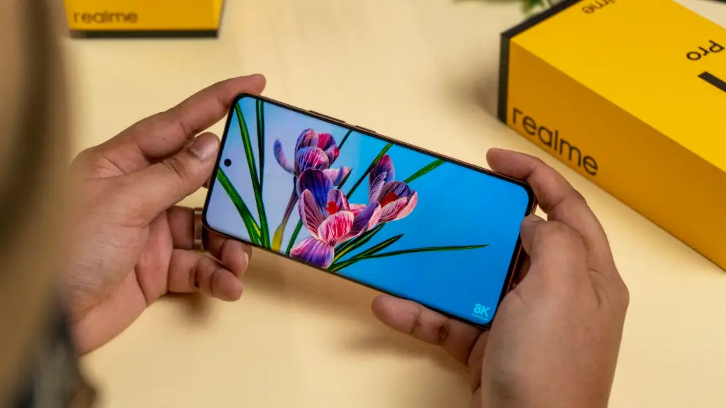 a person holding a cell phone with a picture of flowers on it