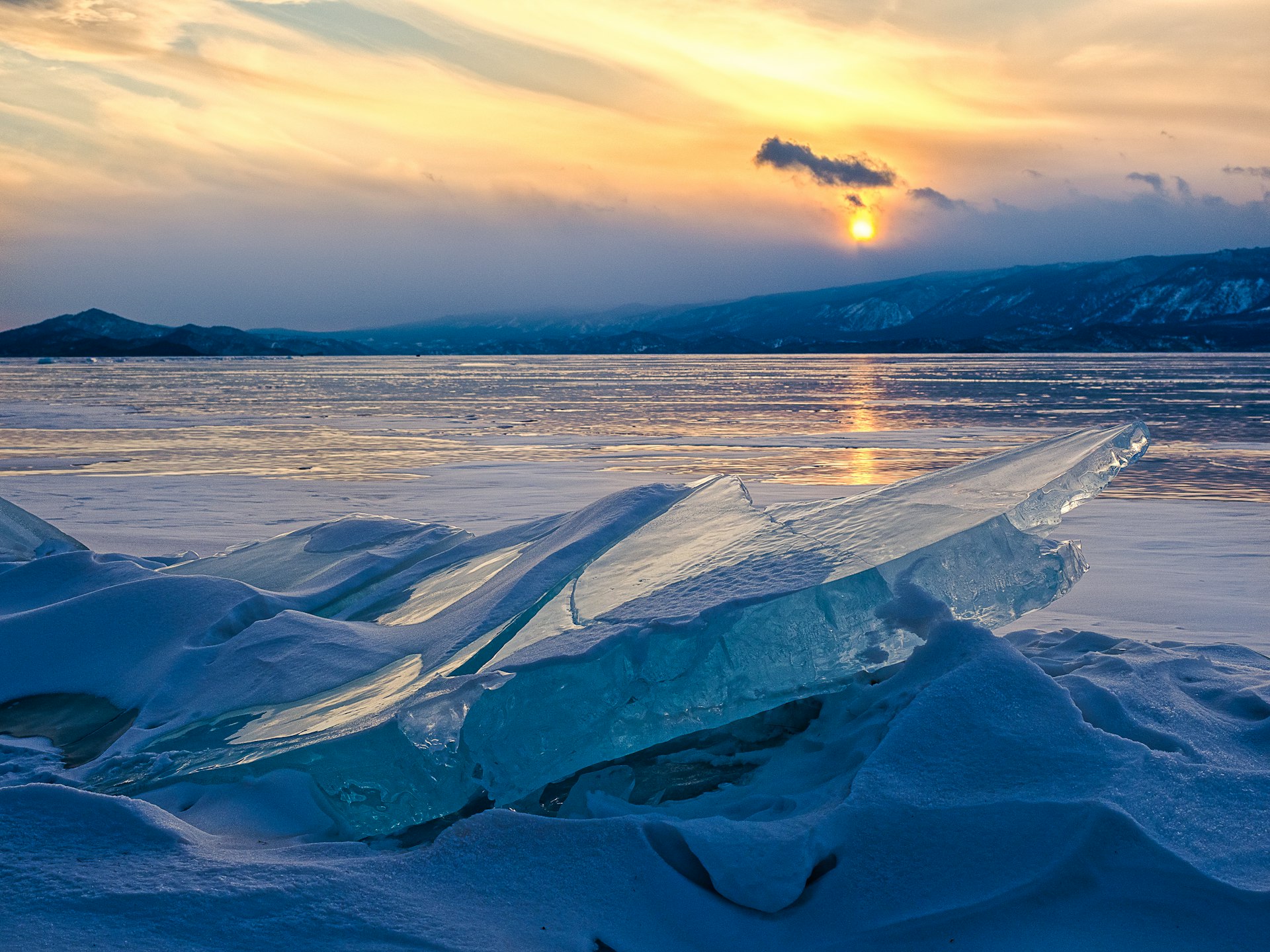 snow covered field during sunset