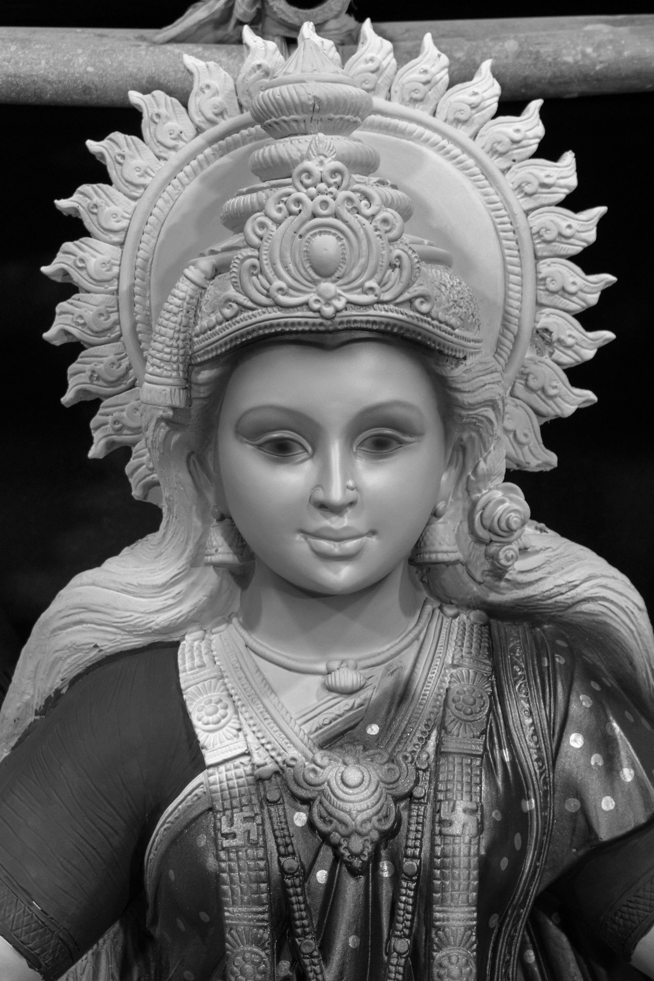 a black and white photo of a statue of a woman
