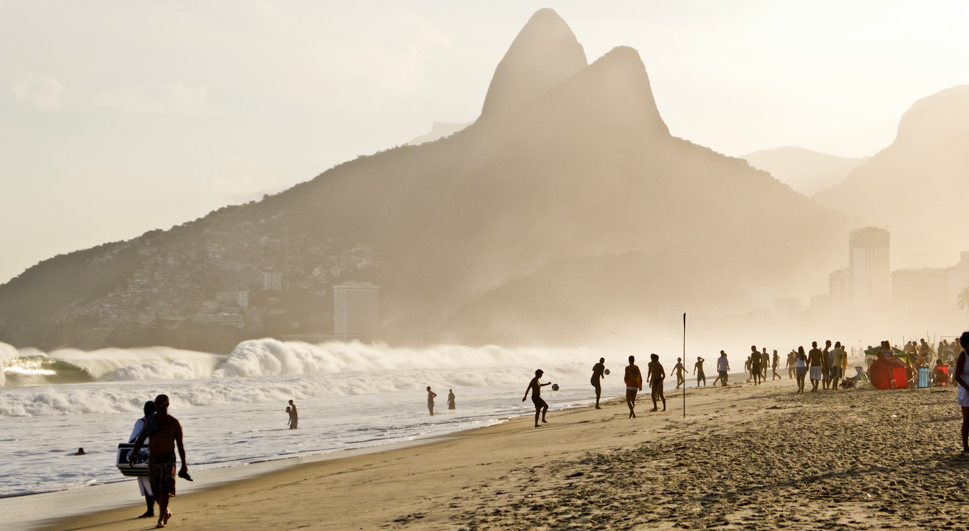 a group of people standing on top of a sandy beach