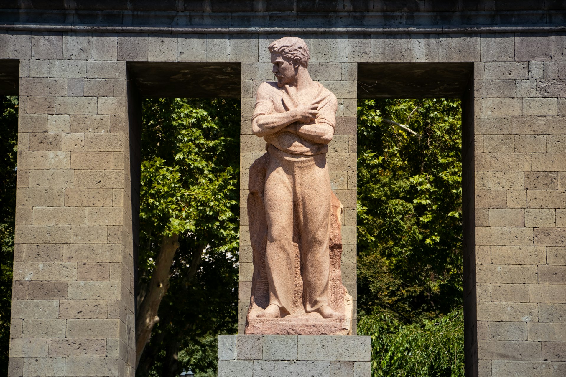 A statue of a man with his arms crossed