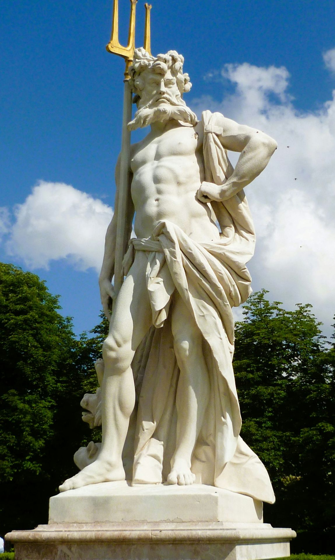 A statue of the greek god poseidon holding a trident.