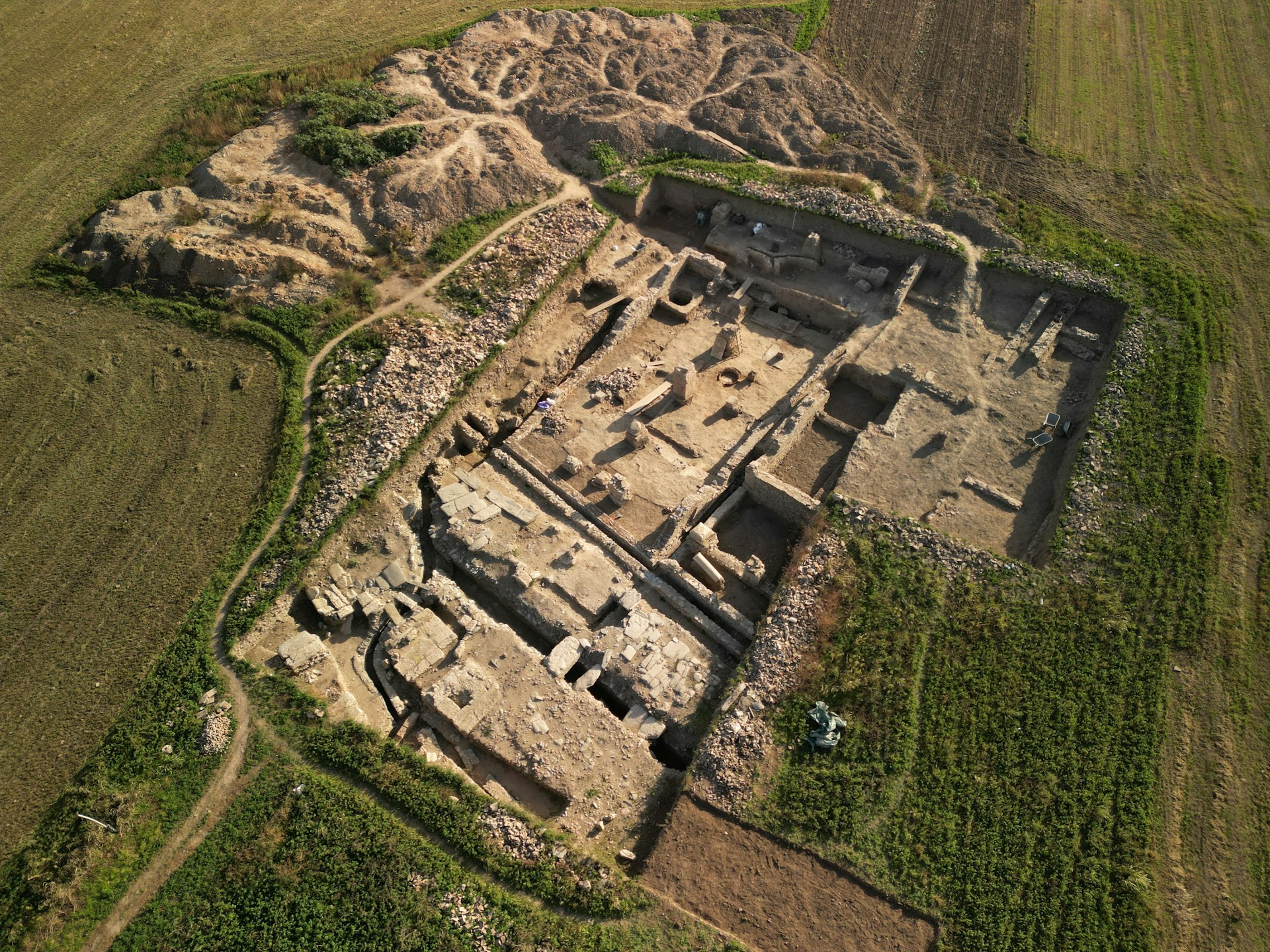 An aerial view of a building in the middle of a field