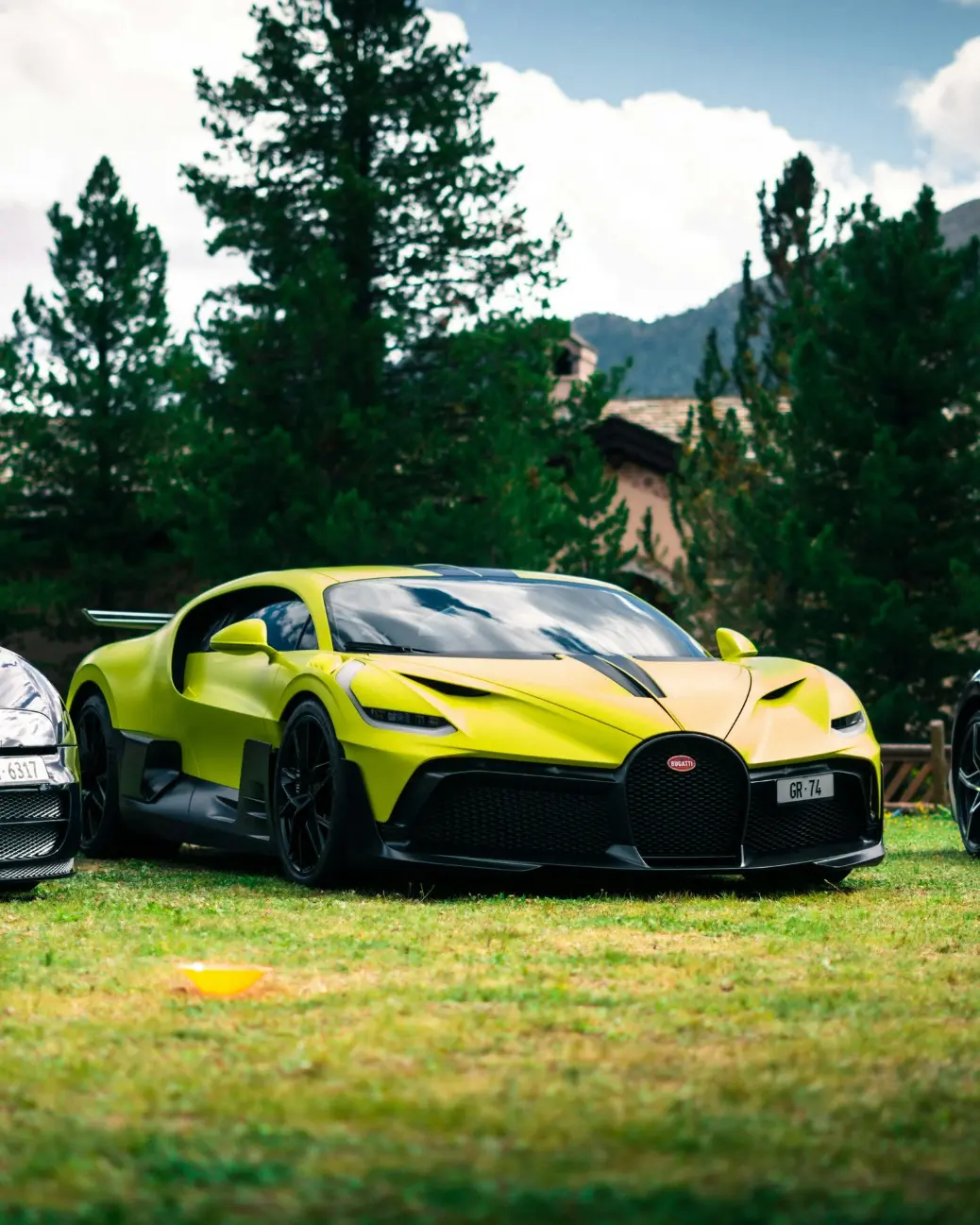 a yellow sports car parked on grass