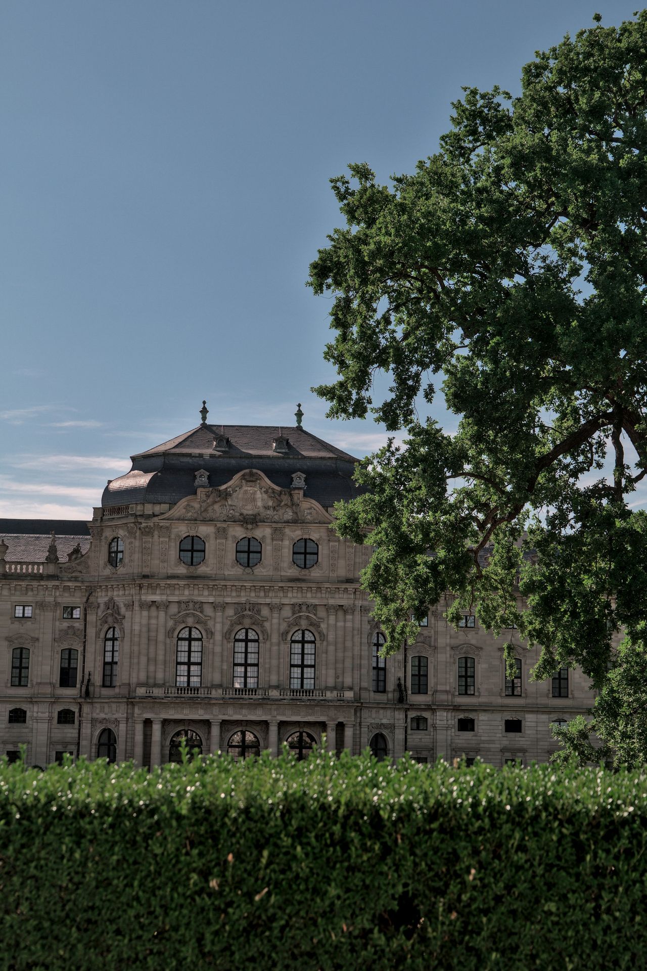 a large building with a tree in front of it