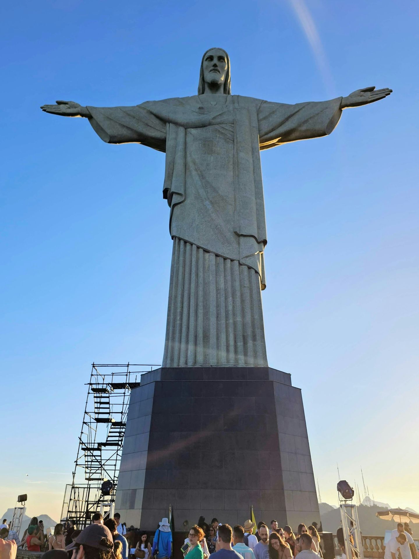 a crowd of people standing around a large statue