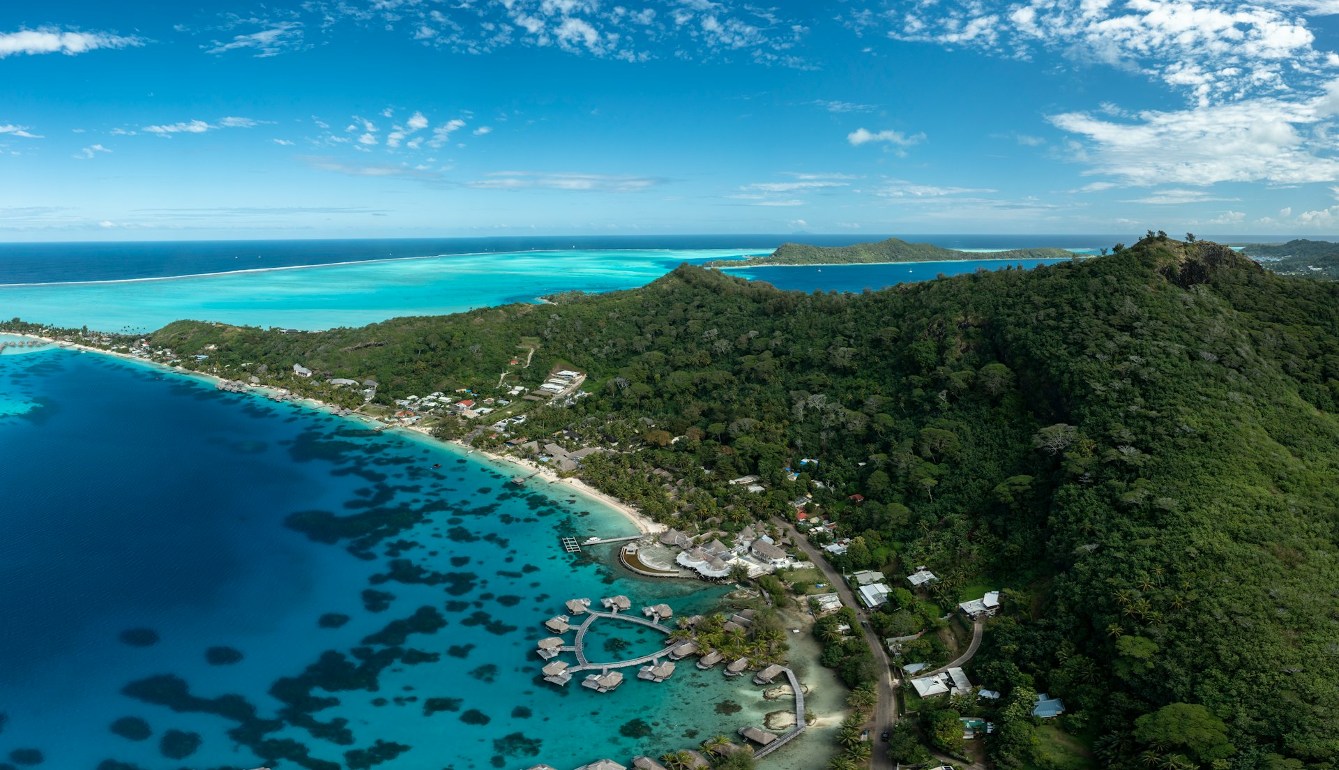 an aerial view of a tropical island in the middle of the ocean