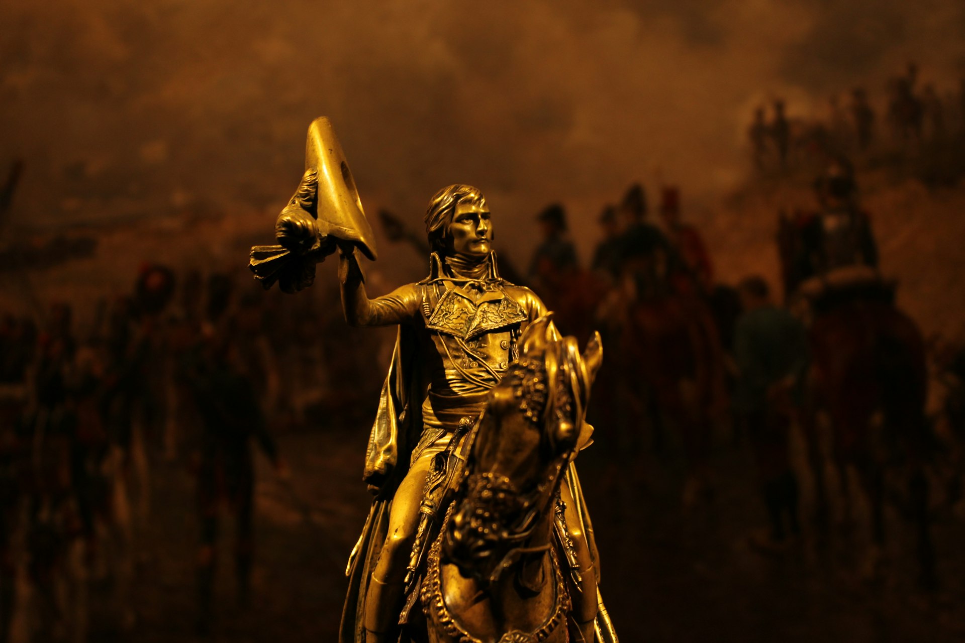 gold statue of man holding gold trophy