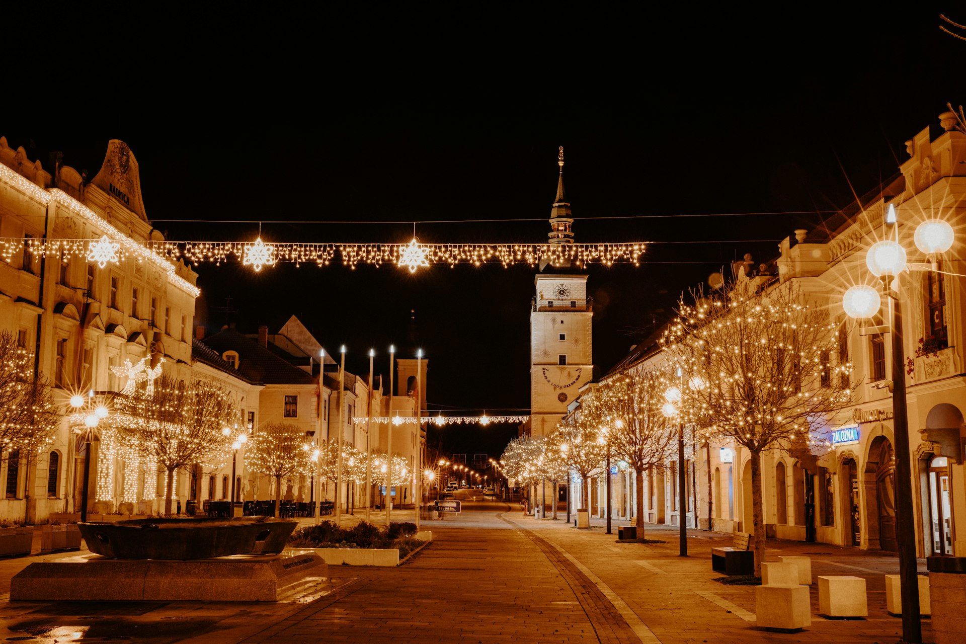 a city street with a clock tower in the background