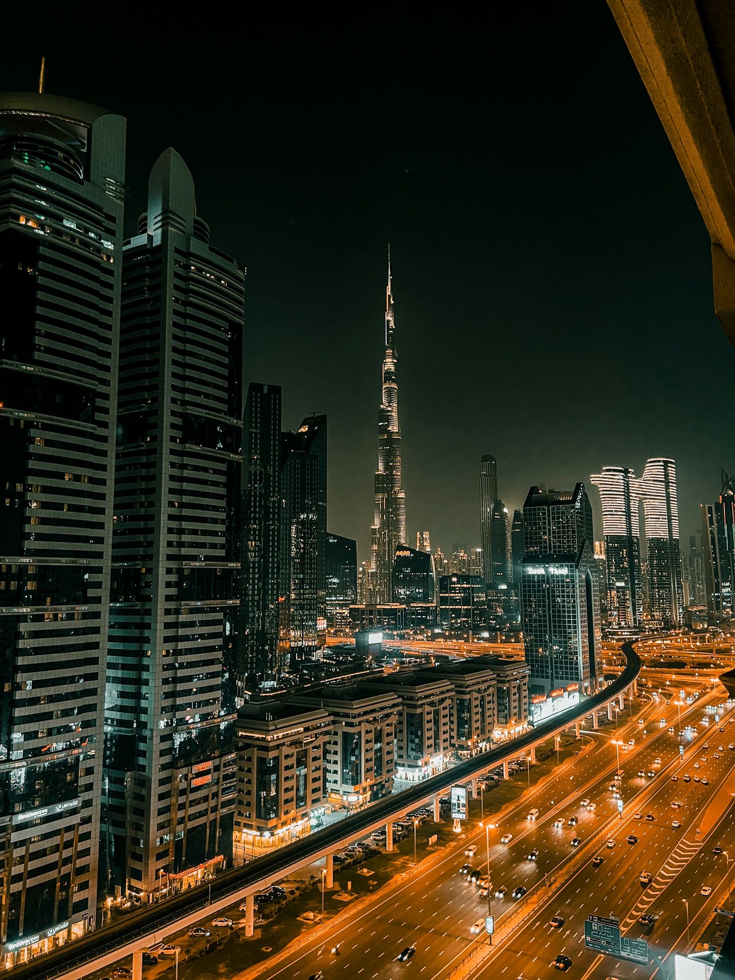 A view of a city at night from the top of a building