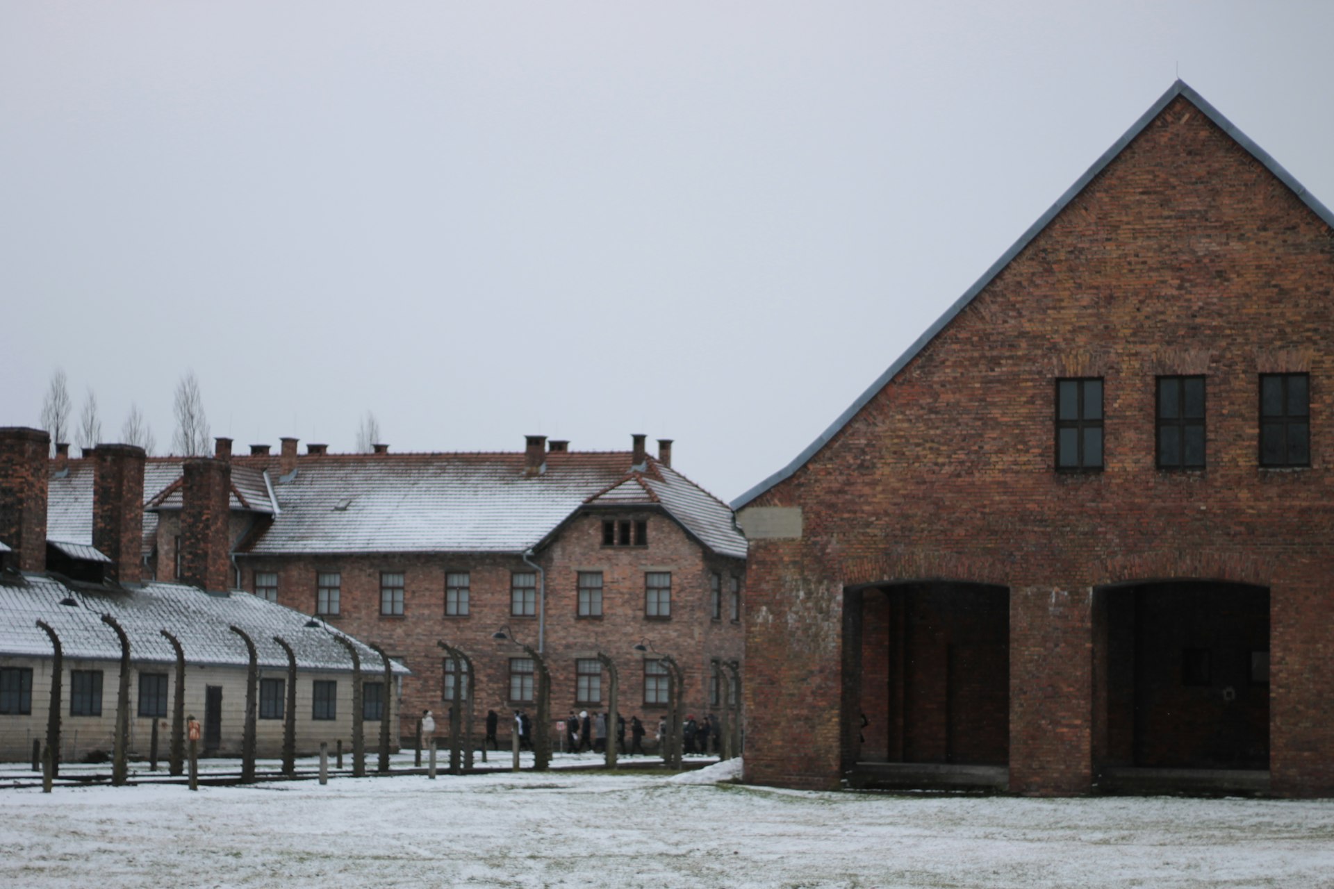 a brick building with a train station in the background